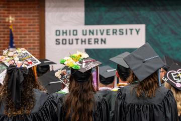 rear view of graduates in caps and gowns
