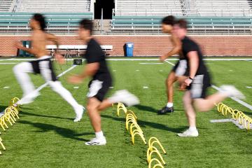 OHIO Football players practice on the field at Peden Stadium