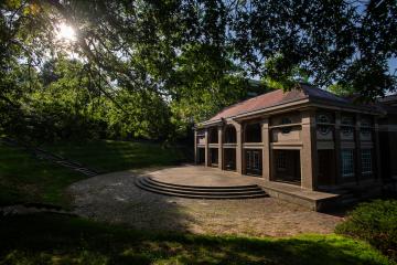 Scripps Hall is shown surrounded by green grass and trees on a summer day