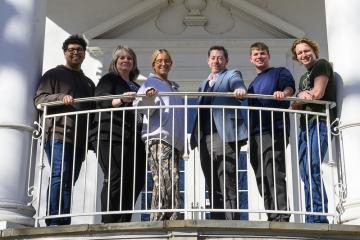 OHIO students and faculty in the Procurement Internship Program stand together on a balcony