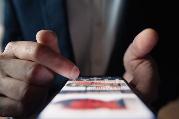 An up-close image of someone scrolling on a social media platform.