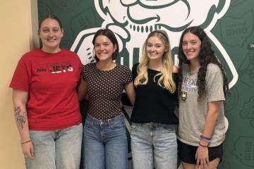 4 Education students standing together smiling