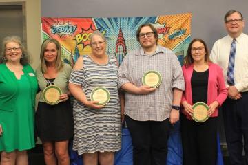 OHIO Business Service Center employees stand together and hold their awards