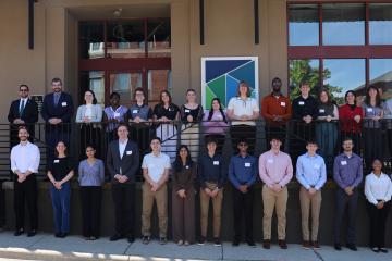 The 2026 MORPC interns stand together for a photo while they are outside in front of a building