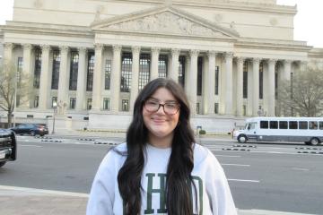 Katie Raines stands in front  of a government building in Washington, D.C.