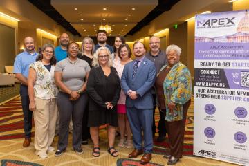 OHIO Apex Accelerator representatives are shown at the national conference, and sign for the conference is next to them.