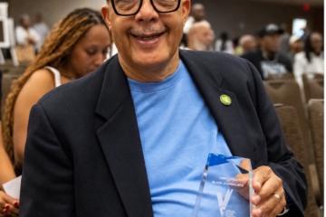 Gary Kirksey holding the award he earned from the NABJ. 