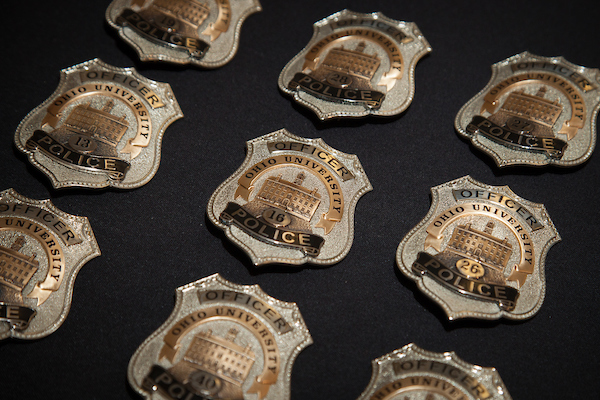 Ohio University Police Department badges line a table