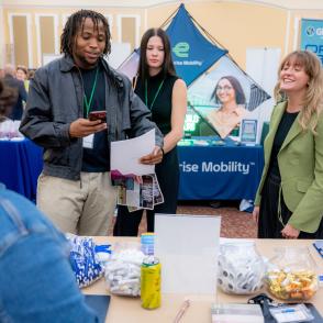 students talking to employers at a career fair
