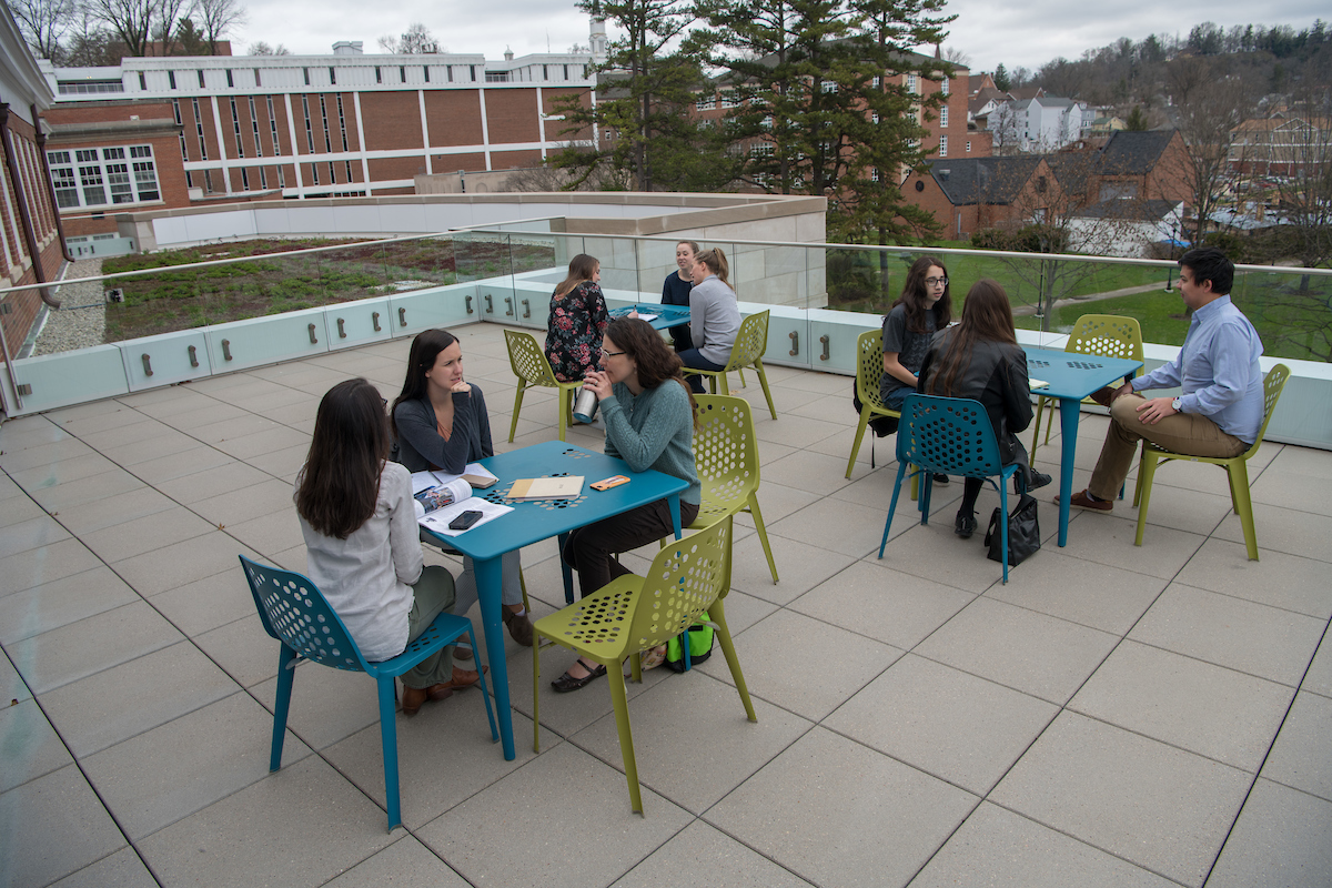 Students and employees sit by the green roof on Patton Hall.