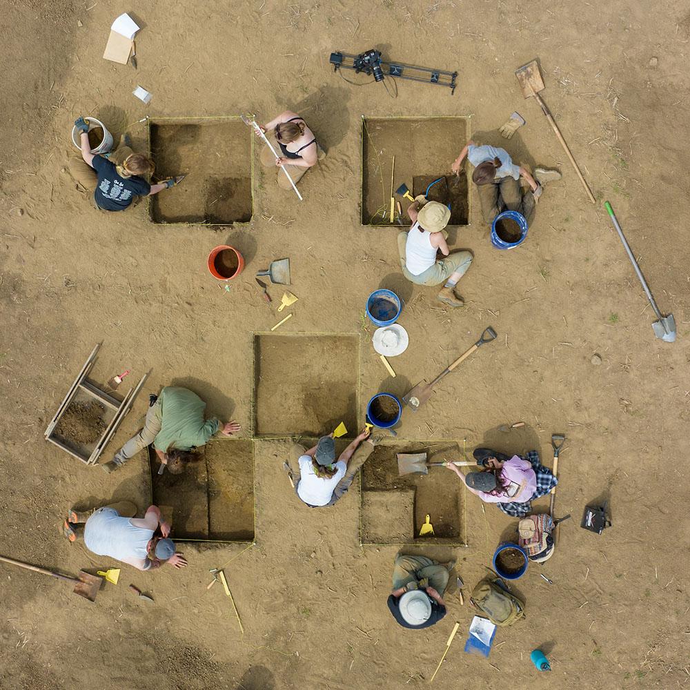 Students dig on an archaeological site.
