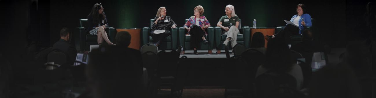 panelists speak at a conference