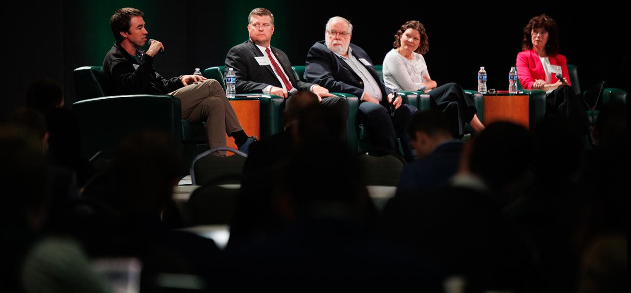 Panelists on stage during the State of the Region Conference speaking. 