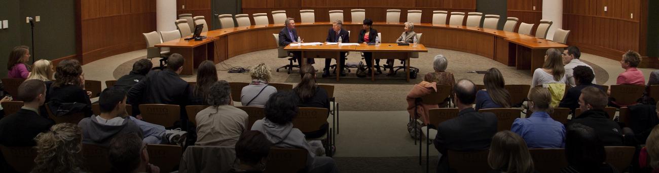 Senator Voinovich speaking on a panel infront of an audience.