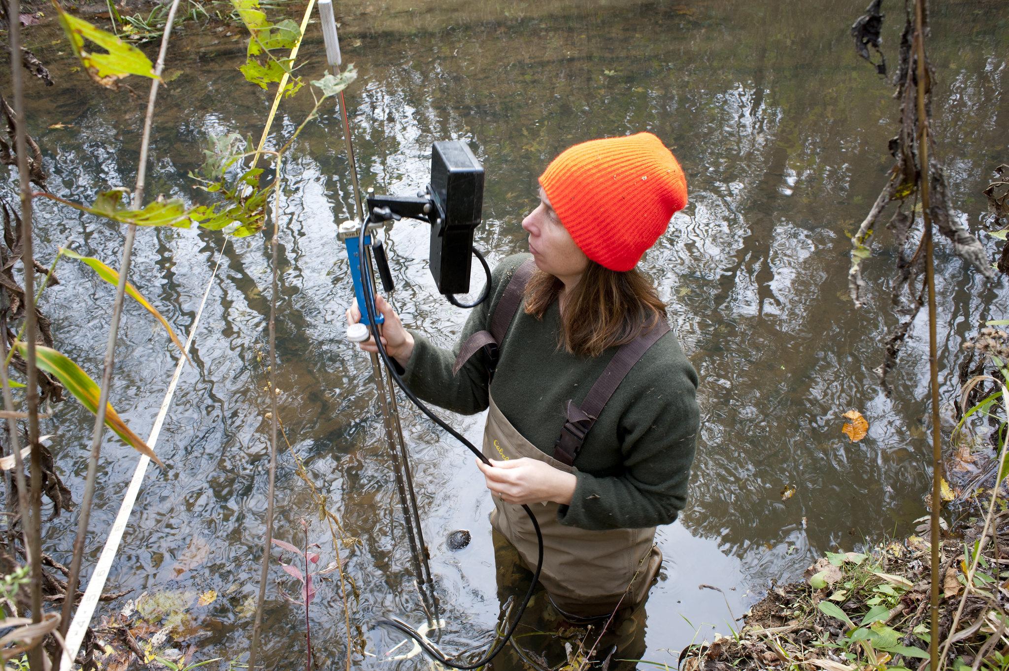 Woman uses tool in a body of water