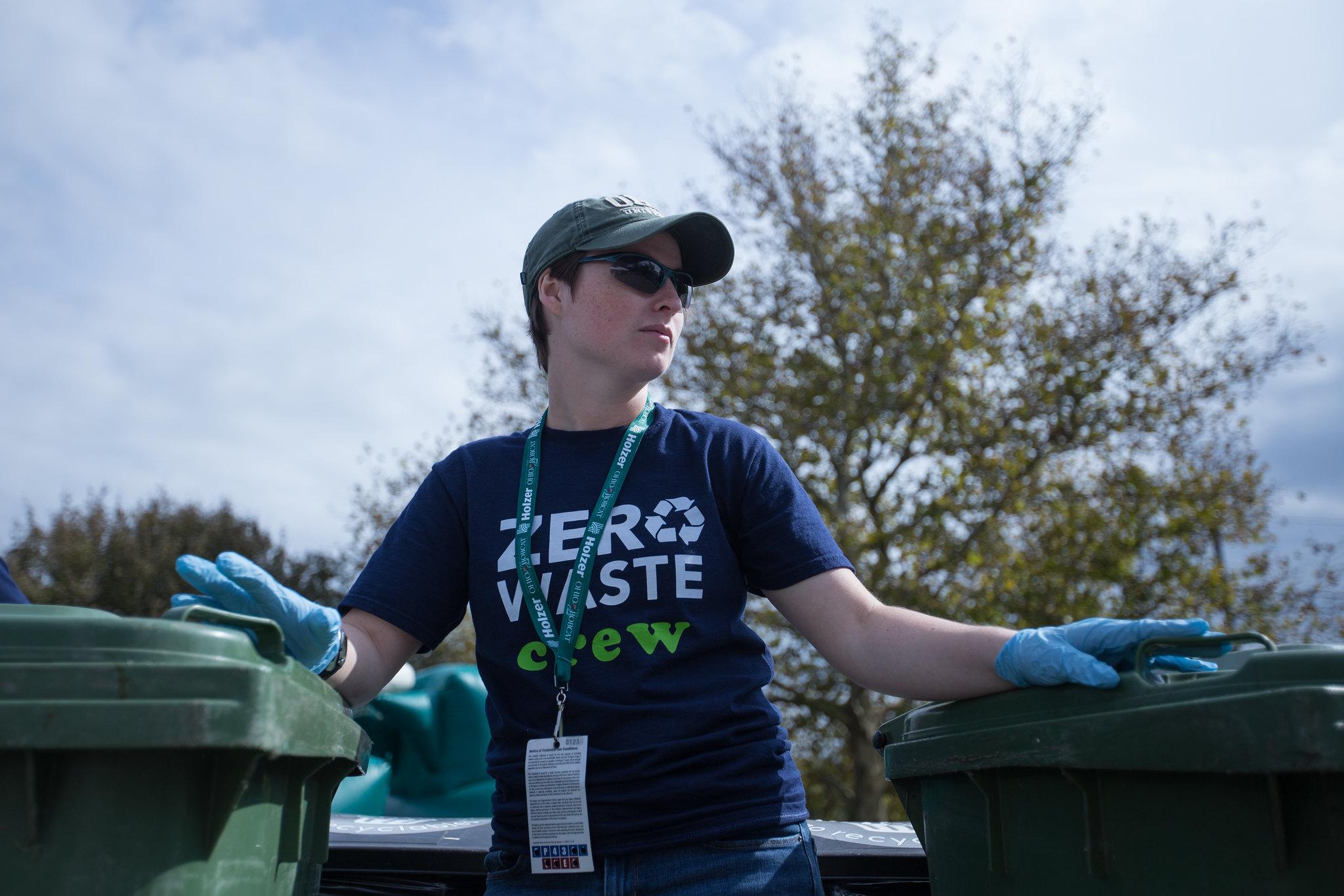 Woman wearing a "zerowaste crew" t-shirt near compost bins 