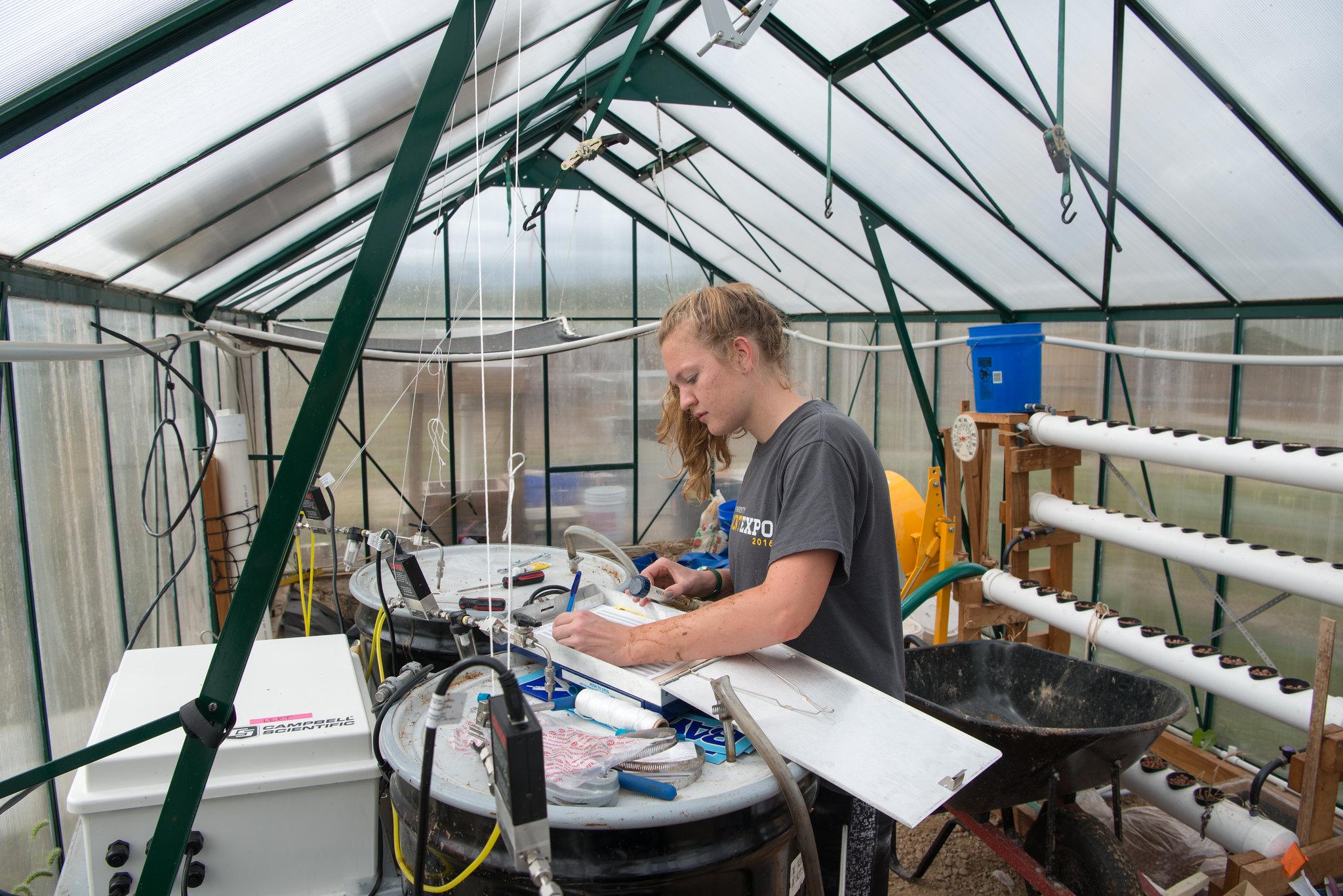 woman works in near a biodigester