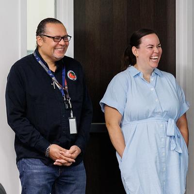 two people laughing in a classroom
