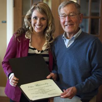 Senator Voinovich presenting Voinovich Scholar with certificate.